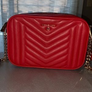 Michael Kors red crossbody purse.
